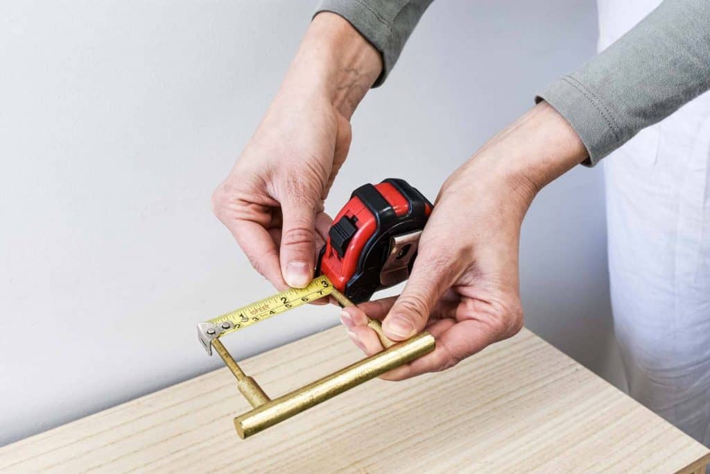 6 . MEASURE HANDLE HOLES